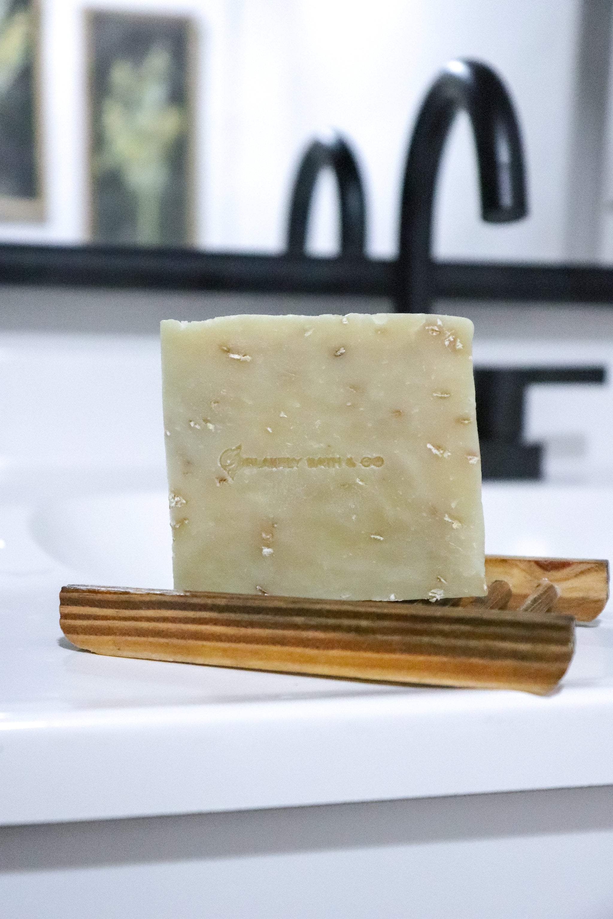 Goat Milk Soap Bar Sitting on soap dish on sink by Blakely Bath & Co