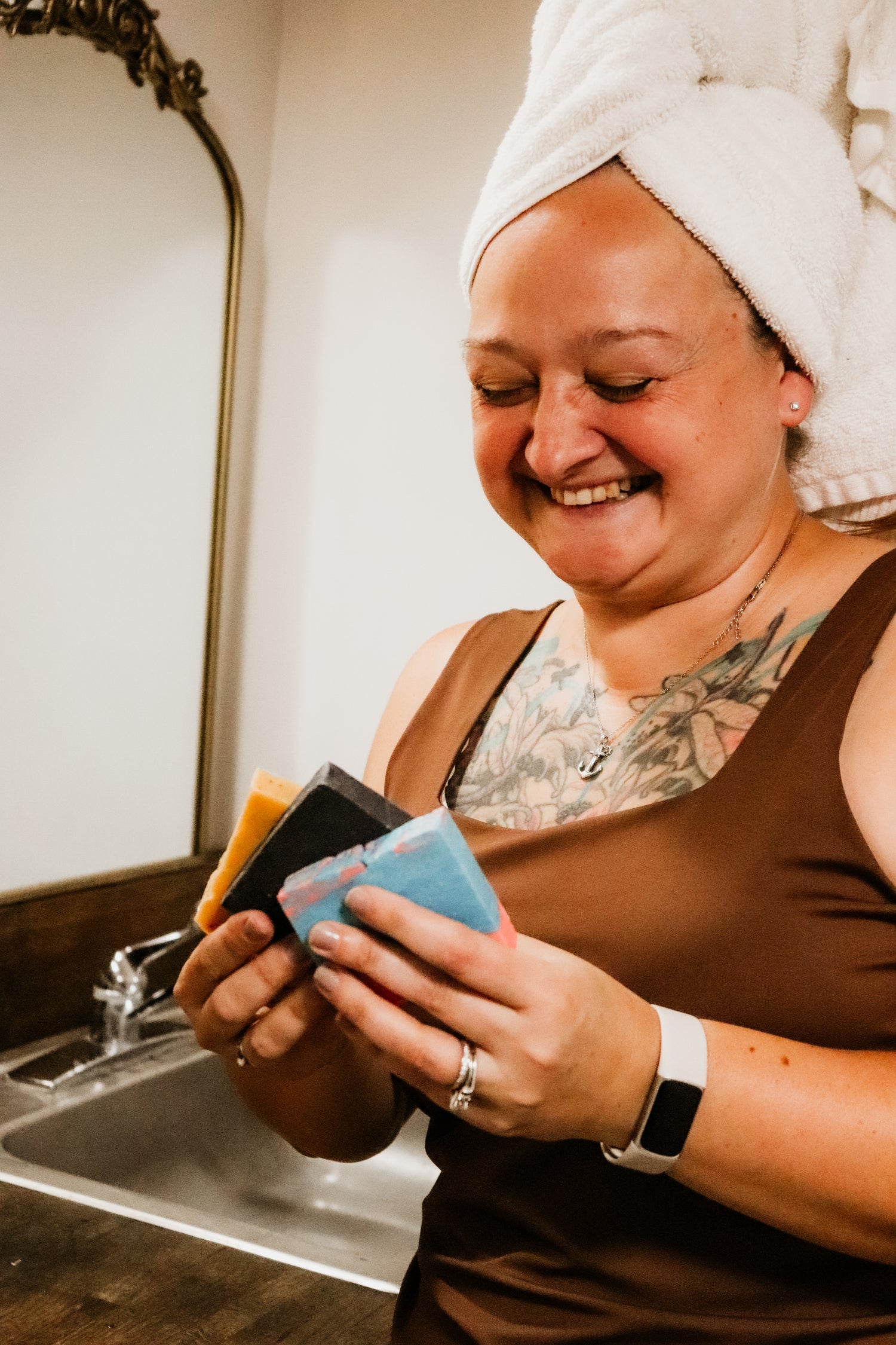 Natural Cleanser Collection — smiling woman holding non-toxic soap bars by Blakely Bath & Co.