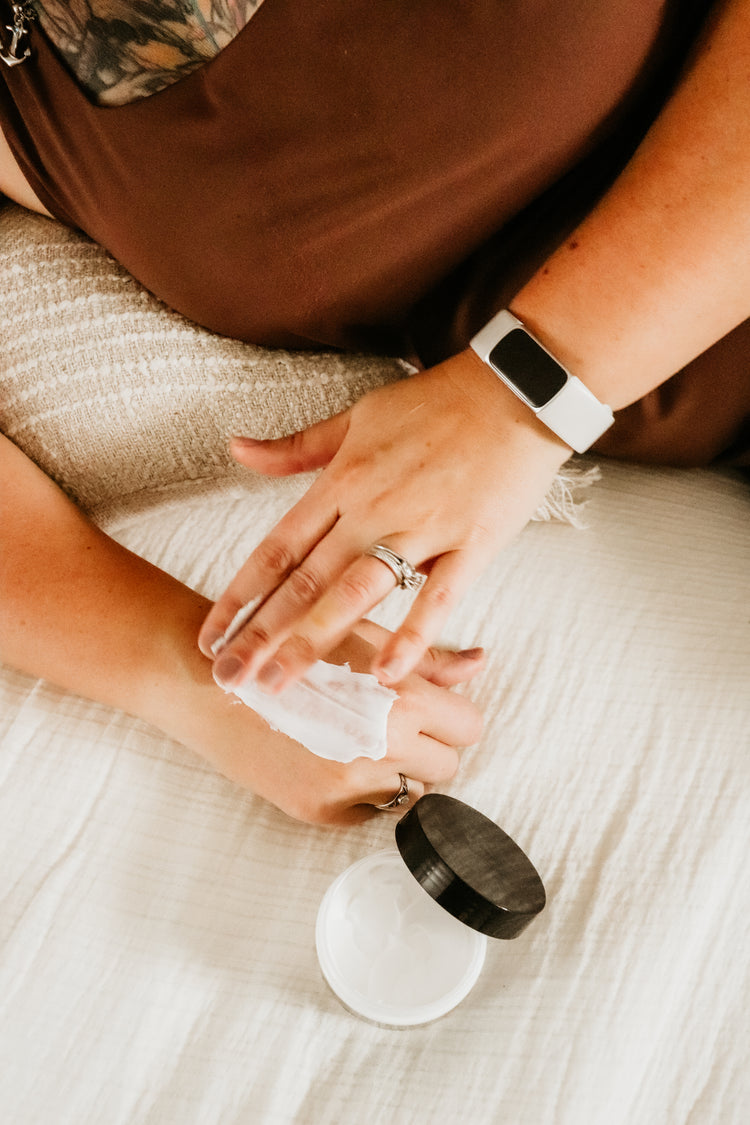 Dry Skin Relief — woman moisturizing dry hands with natural skin care by Blakely Bath & Co.