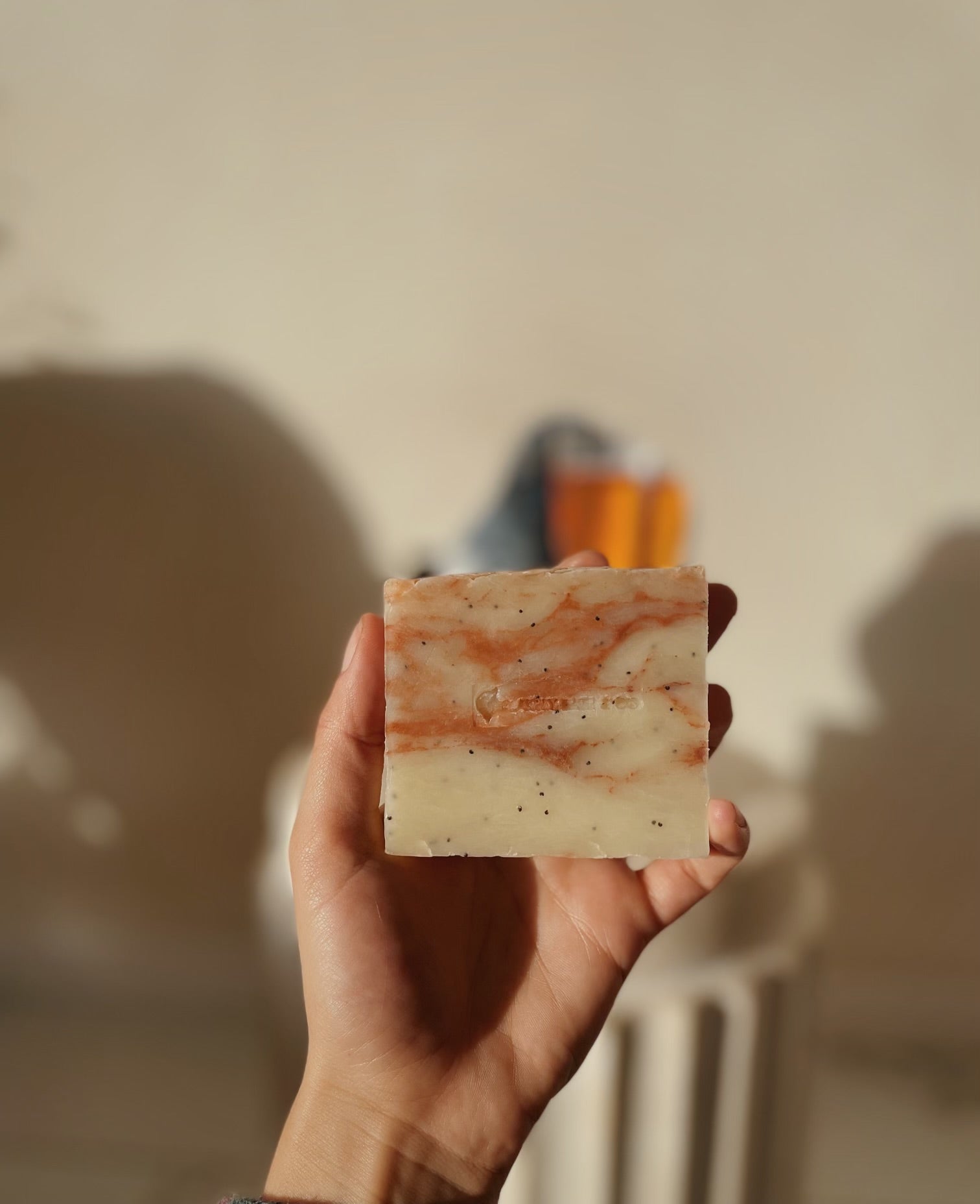 Hand holding bar of Strawberry Bellini Soap Bar