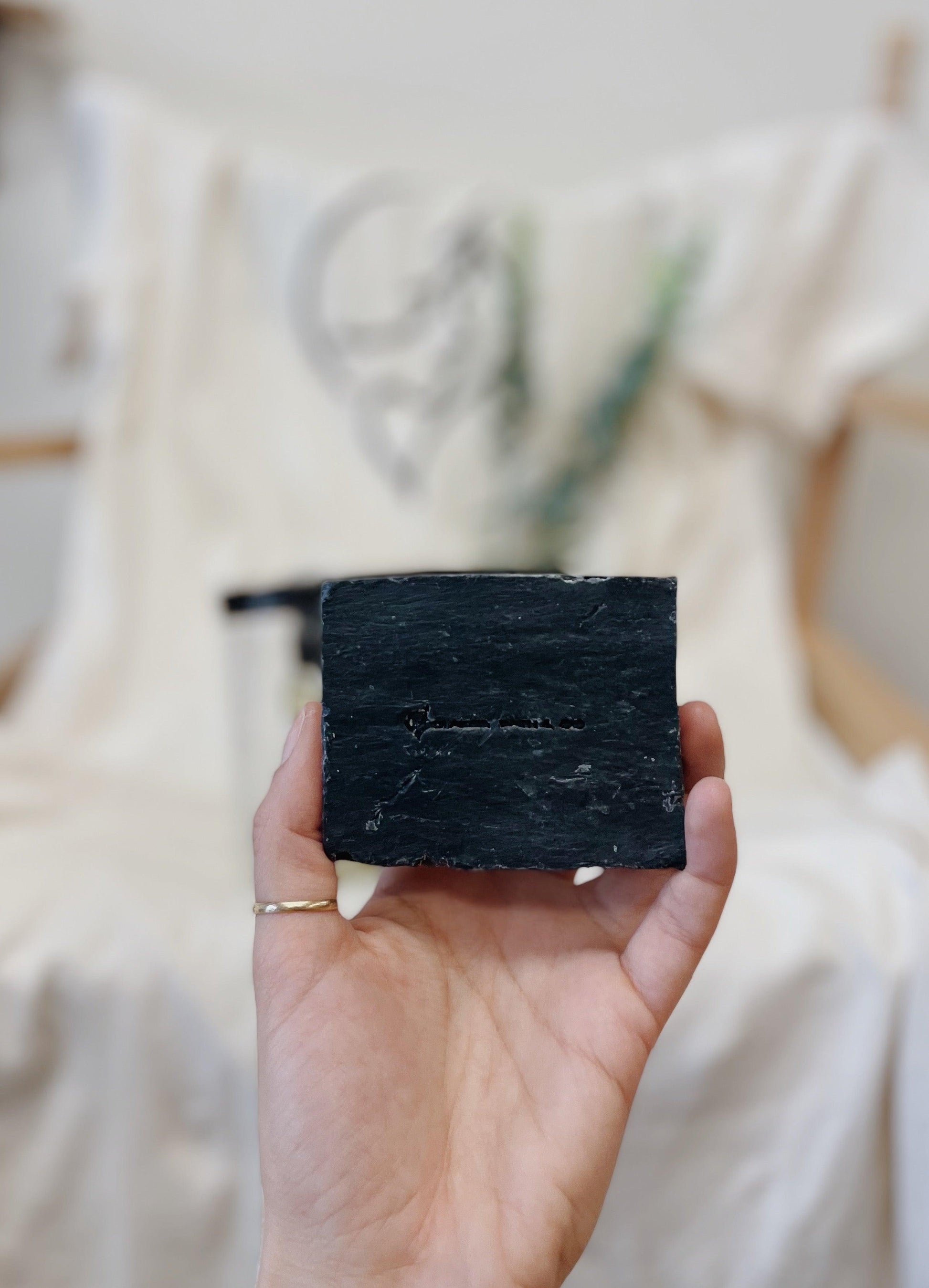 Acne Kit - hand holding the Lavender Charcoal Soap Bar