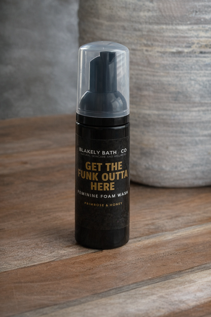 Foam wash bottle with text on a wooden surface