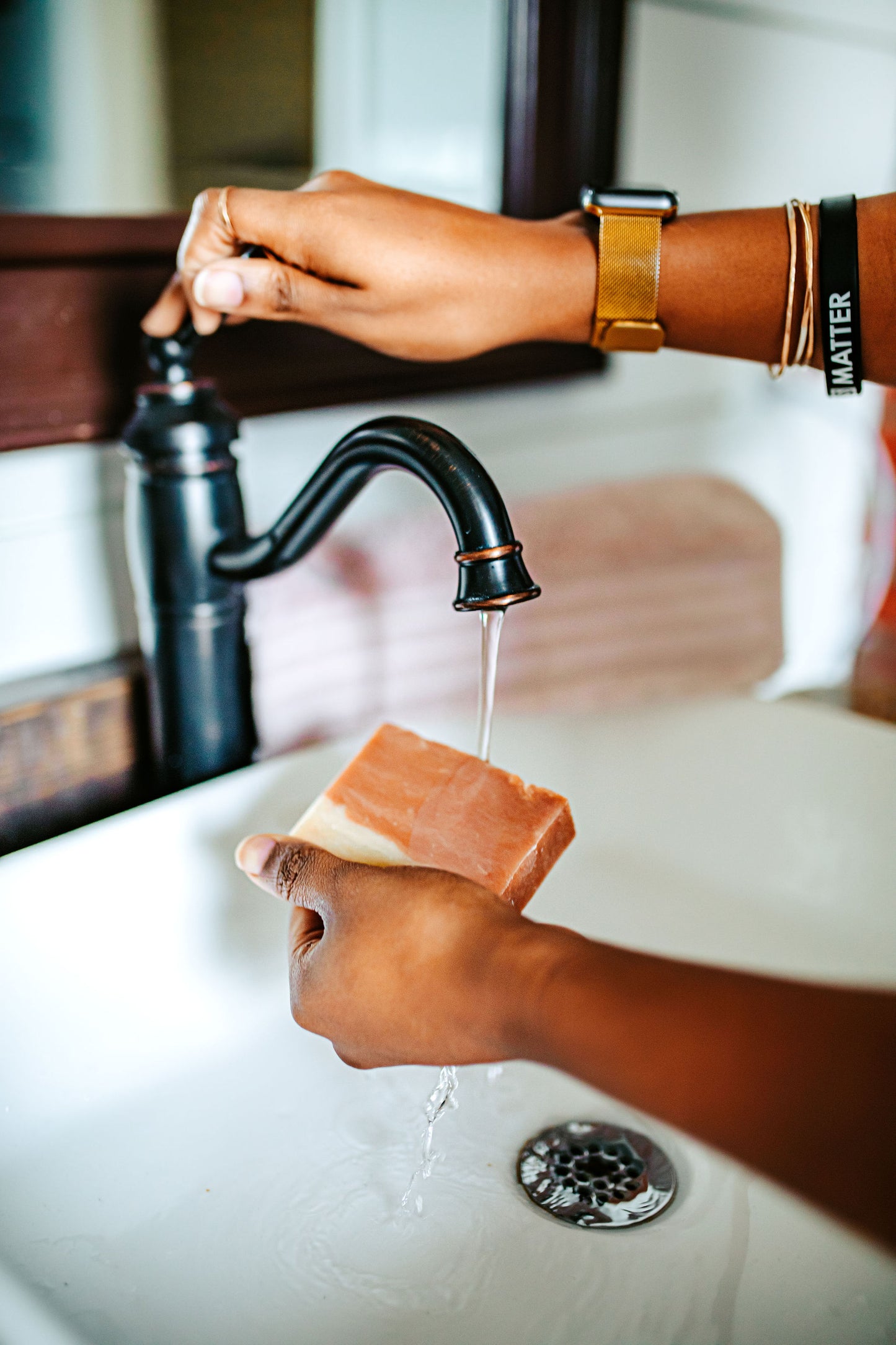 Wasihing hands with Cherry Almond soap bar for nourishing and moisturizing skin, infused with sweet cherry and almond oils for a soothing, aromatic cleanse by Blakely Bath & Co
