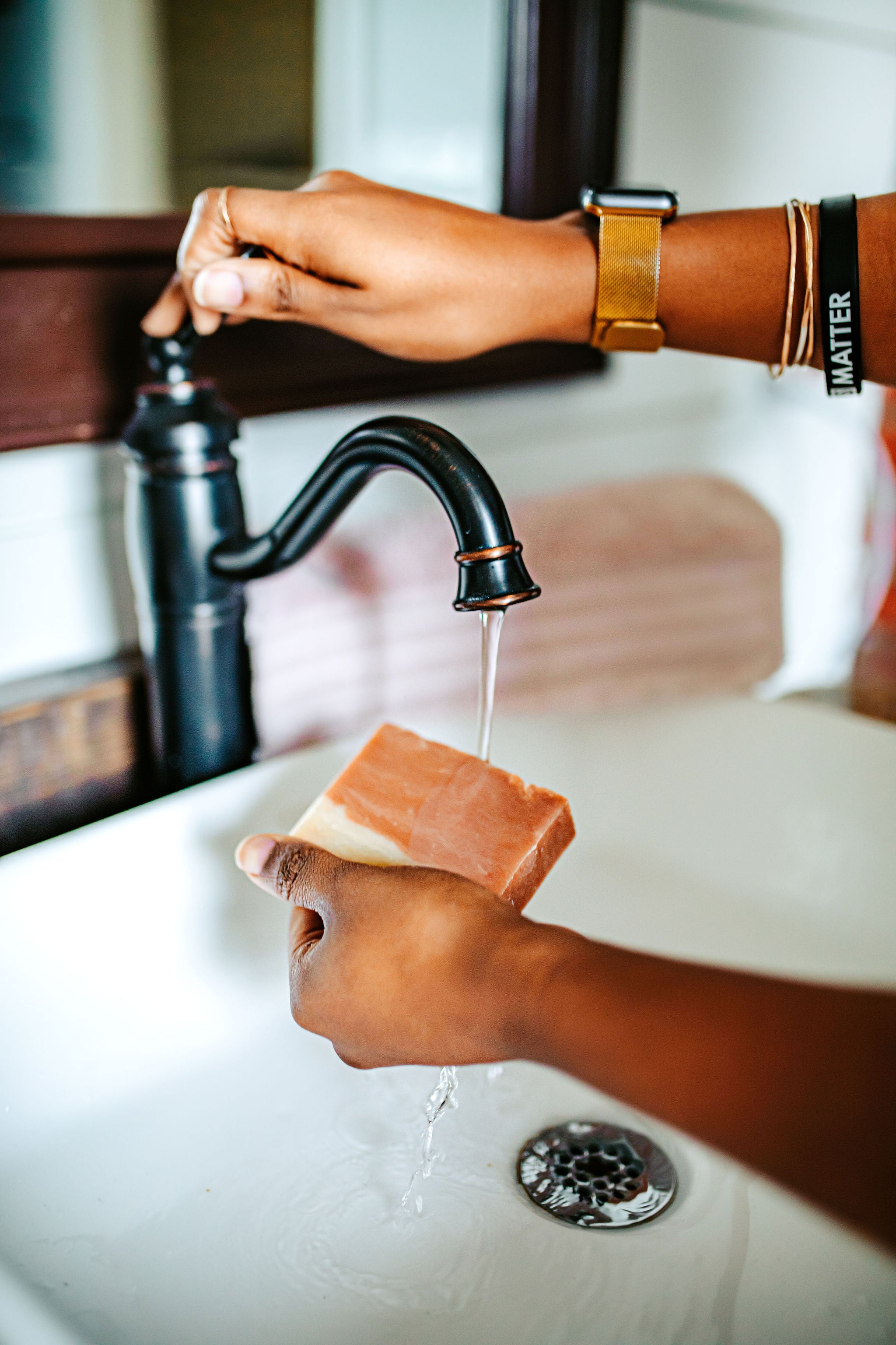 Wasihing hands with Cherry Almond soap bar for nourishing and moisturizing skin, infused with sweet cherry and almond oils for a soothing, aromatic cleanse by Blakely Bath & Co