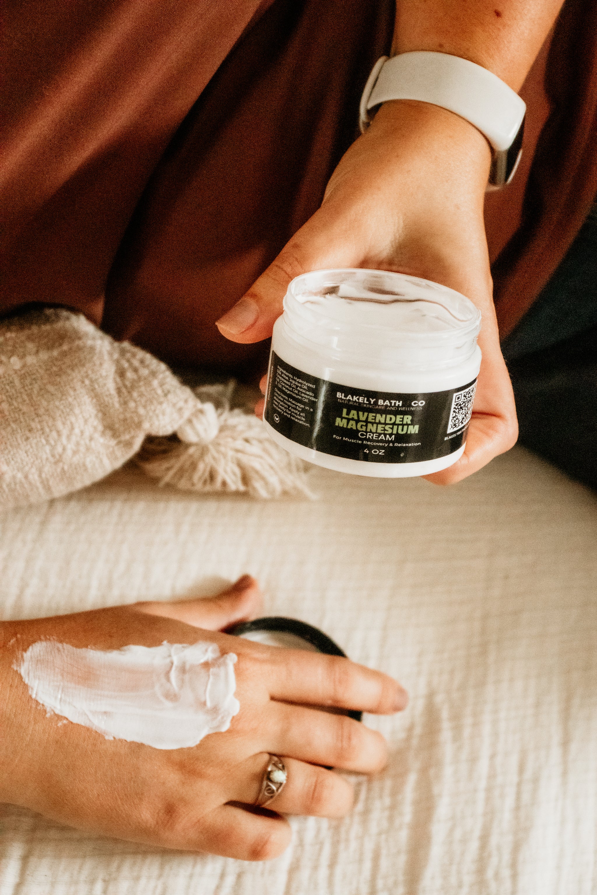 Woman applying Lavender Magnesium cream to their hand from Blakely Bath & Co