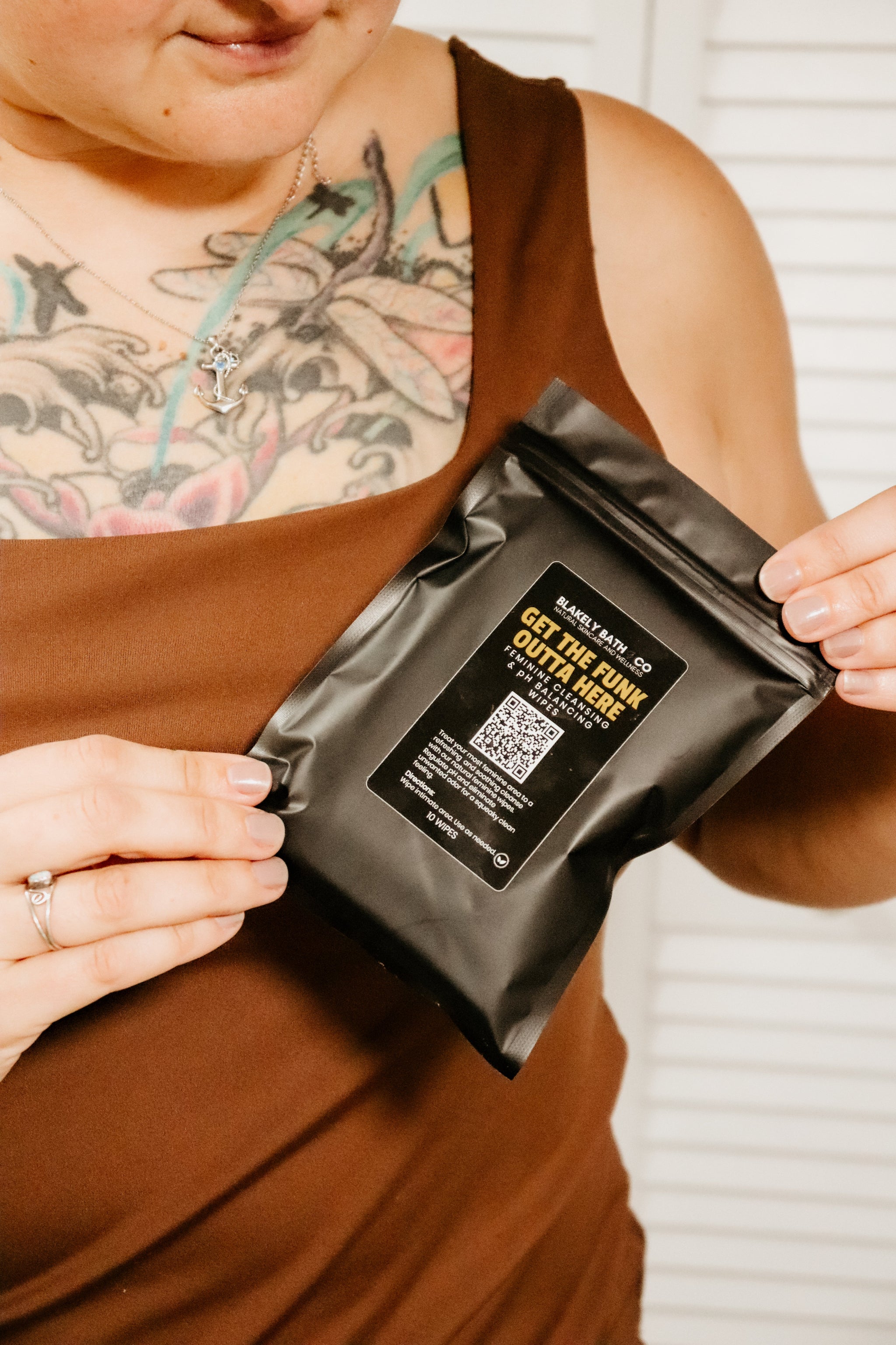 Woman holding Feminine cleansing & pH  balancing wipes by Blakely Bath & Co