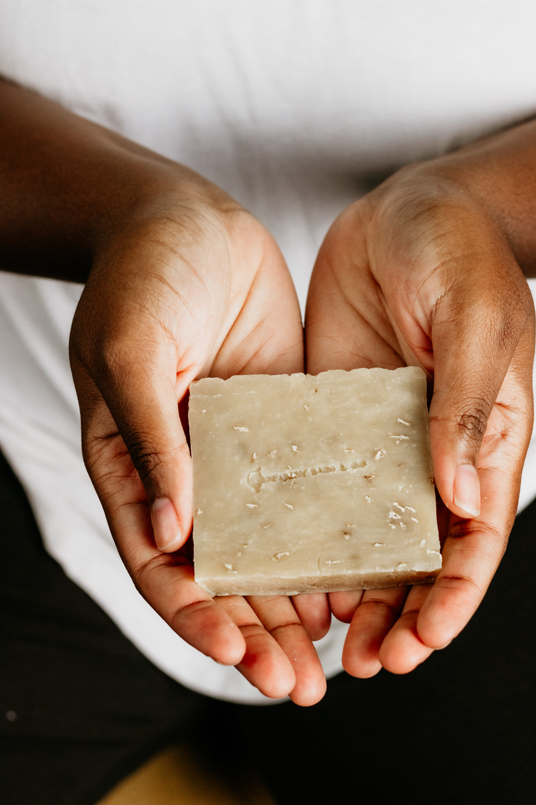 Hand holding a natural goat milk soap bar – moisturizing, handmade, and perfect for sensitive, dry, or eczema-prone skin.
