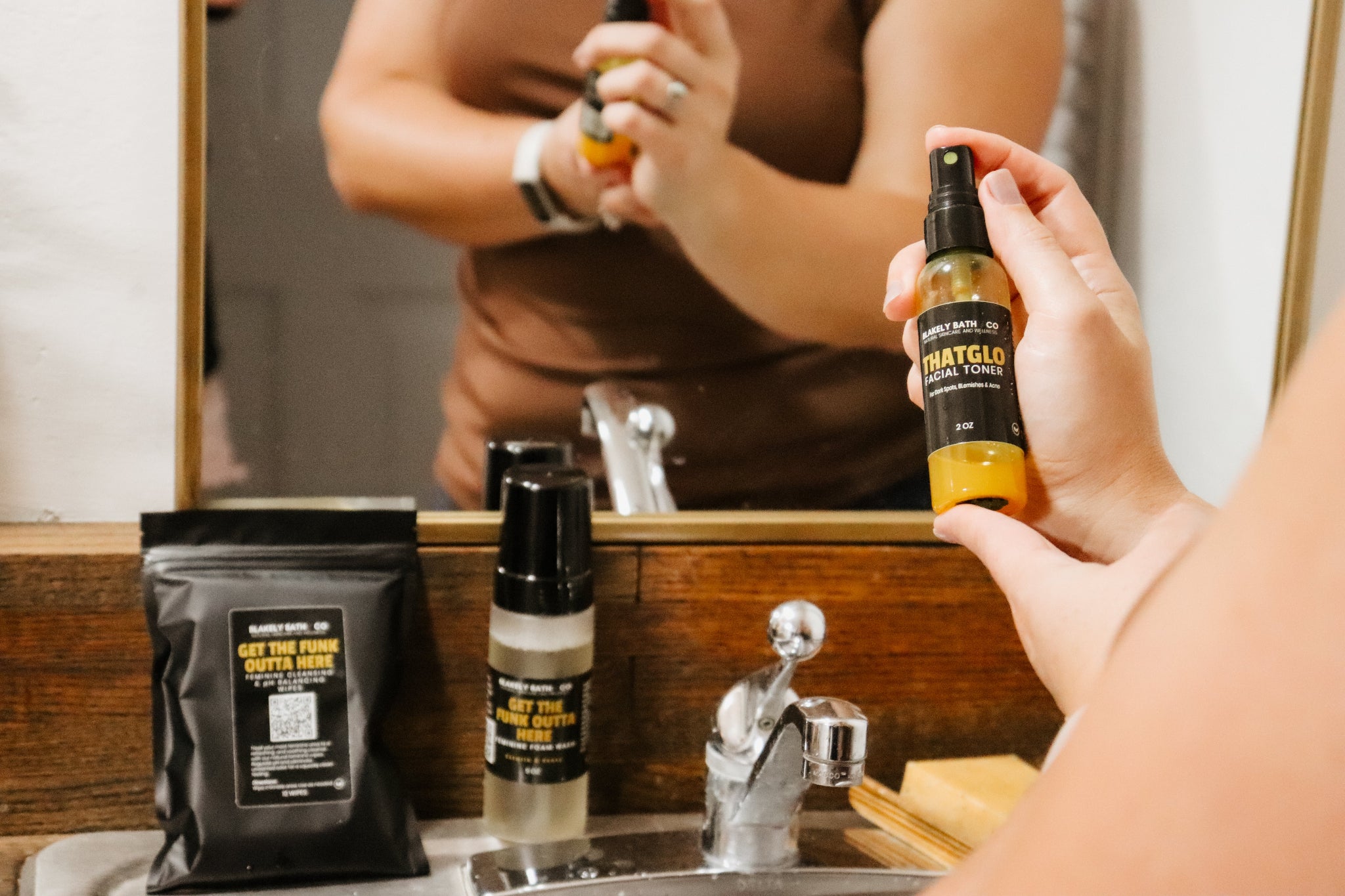 Hand holding ThatGlo Turmeric Face Toner – natural brightening toner for acne, dark spots, and glowing skin by Blakely Bath & Co