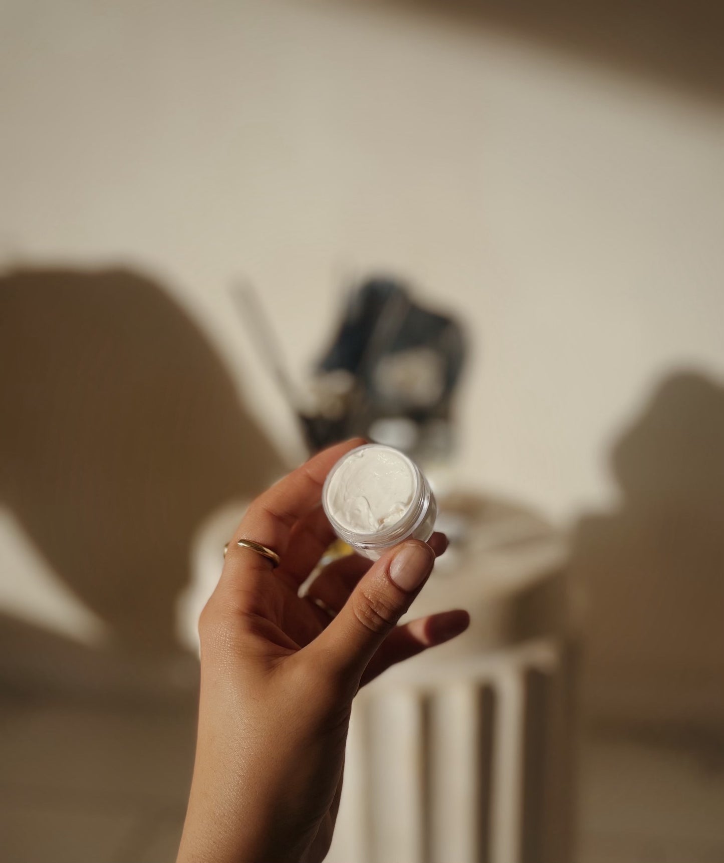 Travel-size Silk Dream Moisturizing Cream by Blakely Bath & Co from Bath Body Store – Tessa Chaplin’s hand shows the compact container’s back, emphasizing nourishing, hydrating benefits for dry, sensitive, on-the-go skincare.