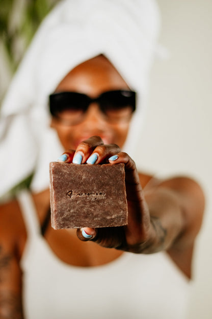 Woman holding handcrafted Hot Girl soap bar – sweet and beachy scented bar with a warm caramel-vanilla aroma