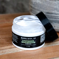Jar of Blakely Bath & Co Lavender Magnesium on a wooden surface with top off