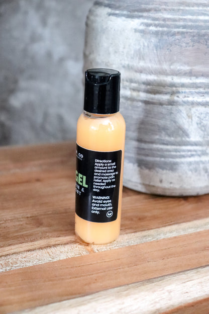 Bottle of pain gel on a wooden surface with a textured wall in the background