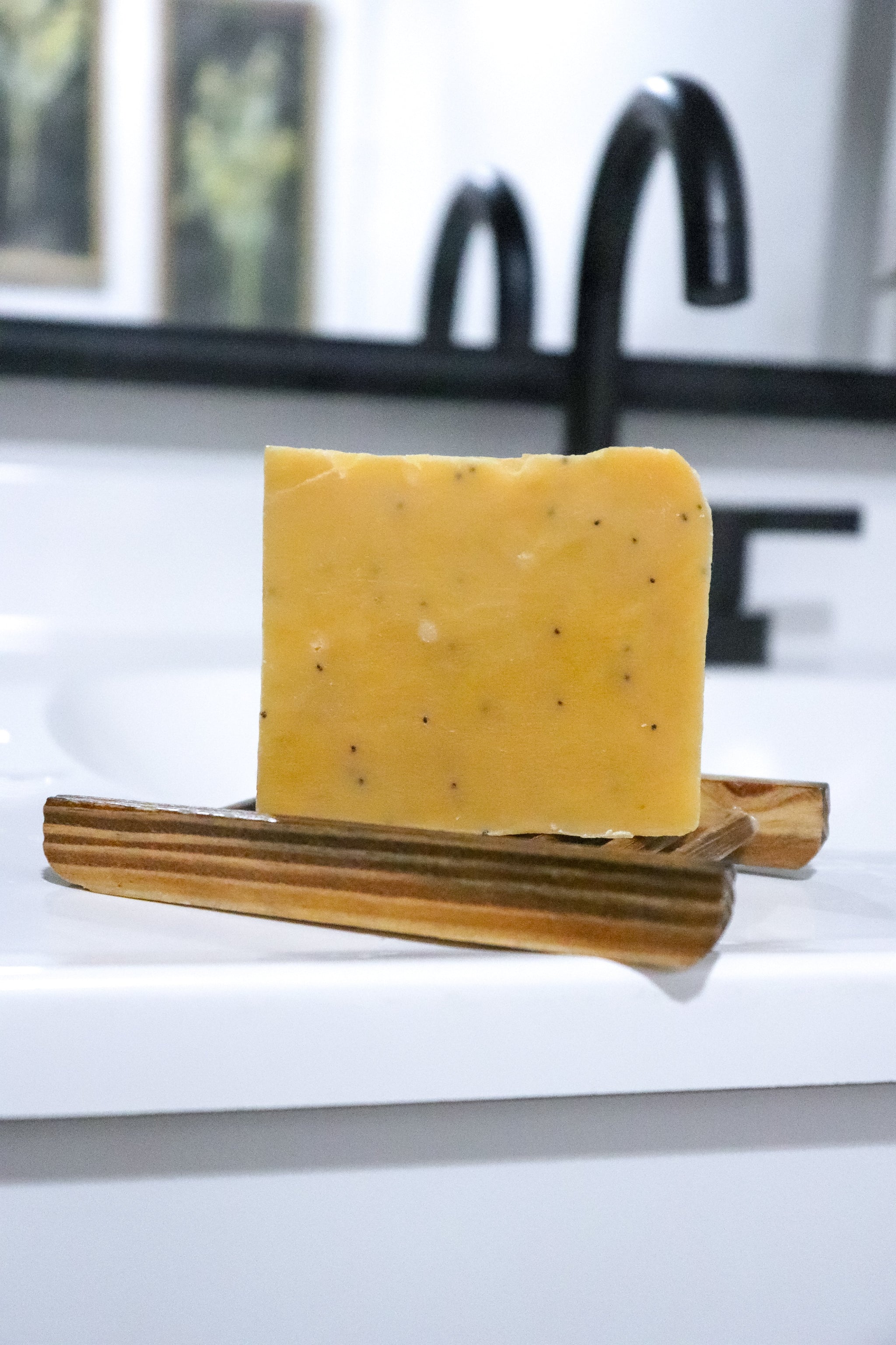 Bar of Pomegranate Pear Exfoliation soap bar  on a wooden soap dish 
