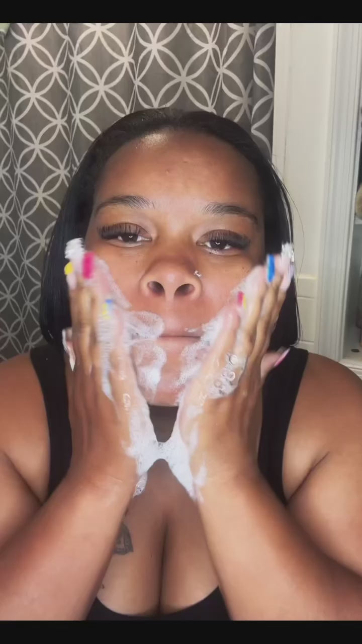 Black woman washing her face with a goat milk soap bar – gentle, moisturizing, and perfect for sensitive or eczema-prone skin.