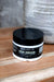 Jar of Blakely Bath Co Silk Dream Face & Body Cream on a wooden surface with a textured gray background best natural skincare moisturizer for radiant, hydrated, and silky smooth skin.