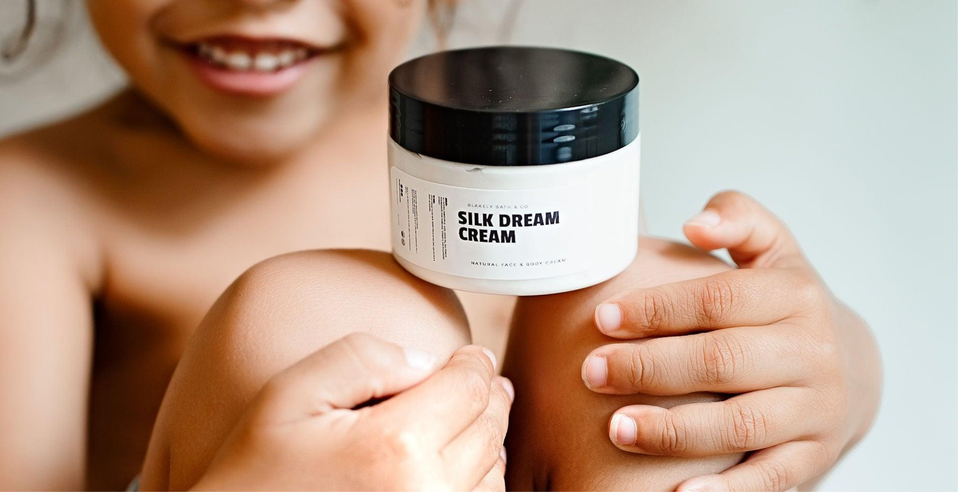 Happy child with eczema-free skin, enjoying the soothing benefits of Silk Dream Moisturizing Cream by Blakely Bath & Co, providing nourishment and relief for clear, smooth skin