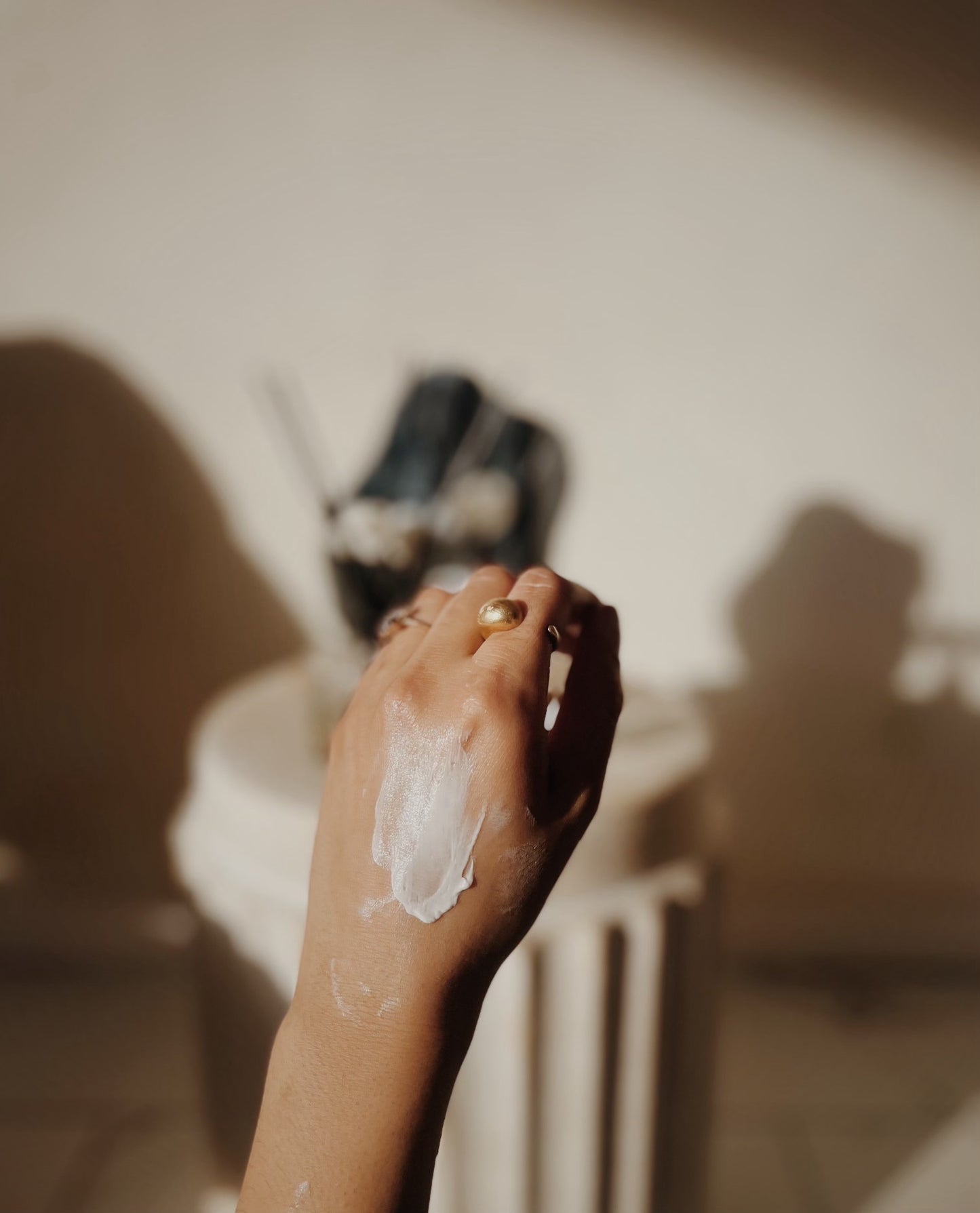 Girl's hand with a smear of silk dream moisturizing cream on it