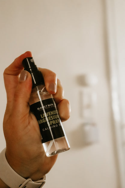 Hand holding a bottle of 'Blakely Bath & Co Lavender magnesium spray 