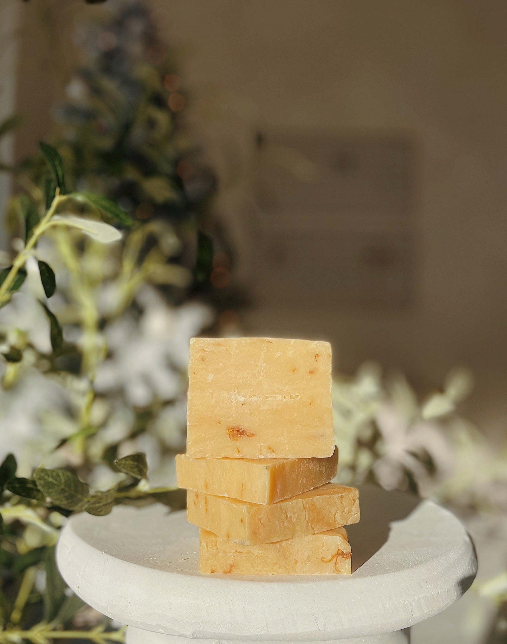 Stack of ThatGlo Turmeric Soap Bars by Blakely Bath & Co, a natural soap infused with turmeric to brighten skin, reduce dark spots, and promote a glowing complexion
