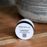 Travel size jar of Silk Dream Cream by Blakely Bath & Co label on a wooden surface