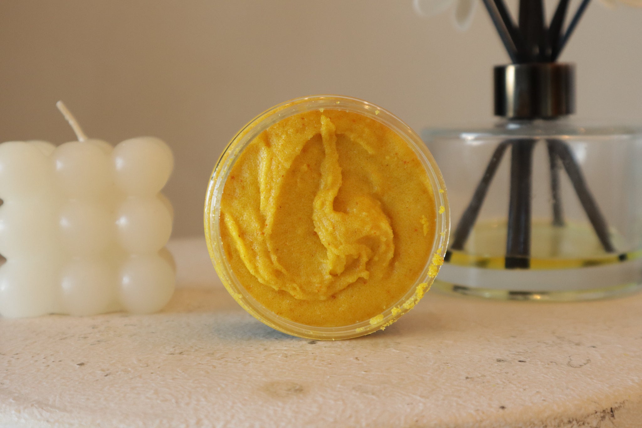 Blakely Bath & Co ThatGlo Turmeric & Kojic Acid Scrub – a rich, golden-yellow orange exfoliator with a creamy, texture