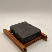 Blakely Bath & Co Eco-Friendly Bamboo Soap Dish holding a lavender charcoal soap bar, offering a sustainable solution to keep your soap dry and extend its life, with a natural, minimalist design